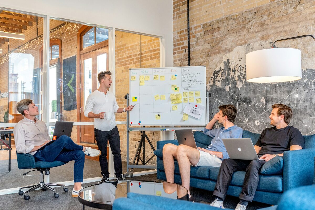 A team working through a plan at a whiteboard